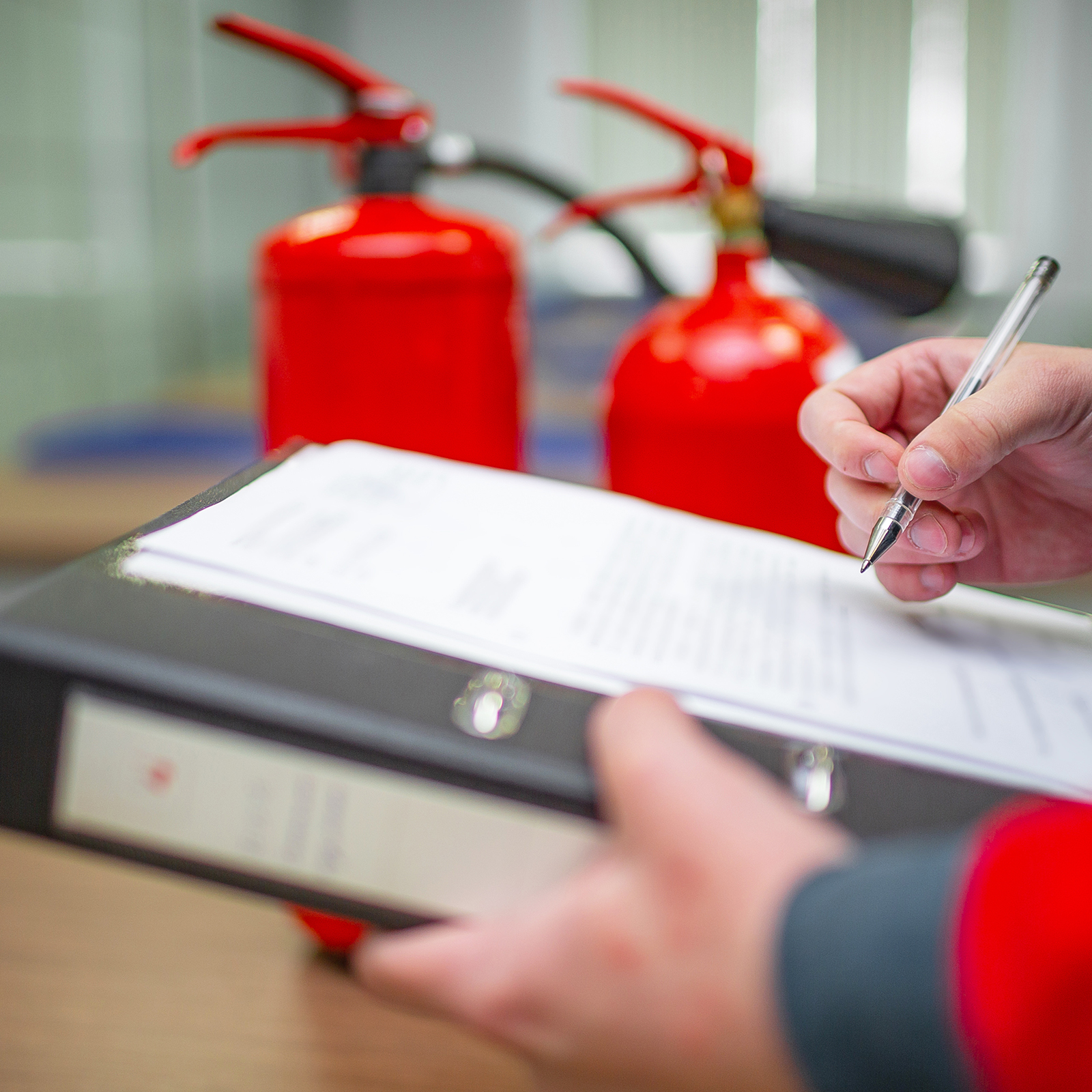 Fire safety inspection in progress with fire extinguishers and checklist visible